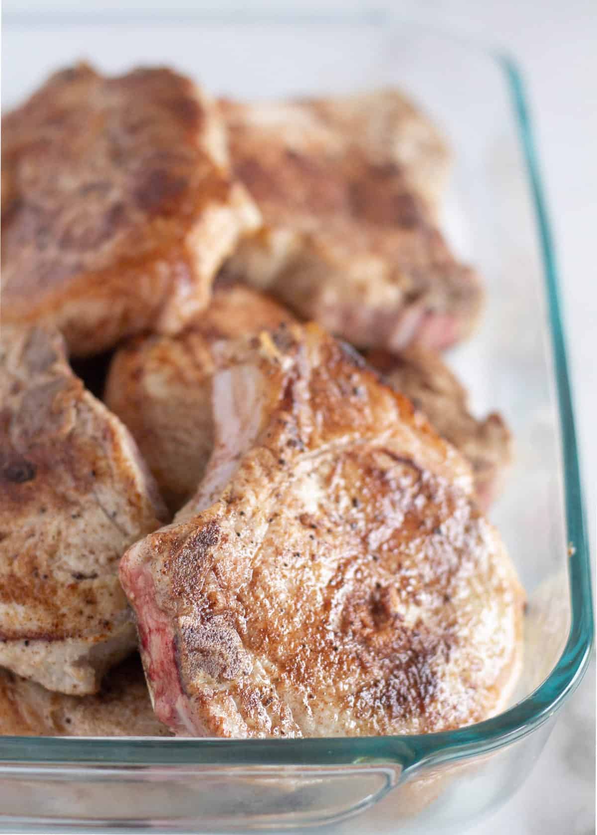 Browned pork chops in baking dish