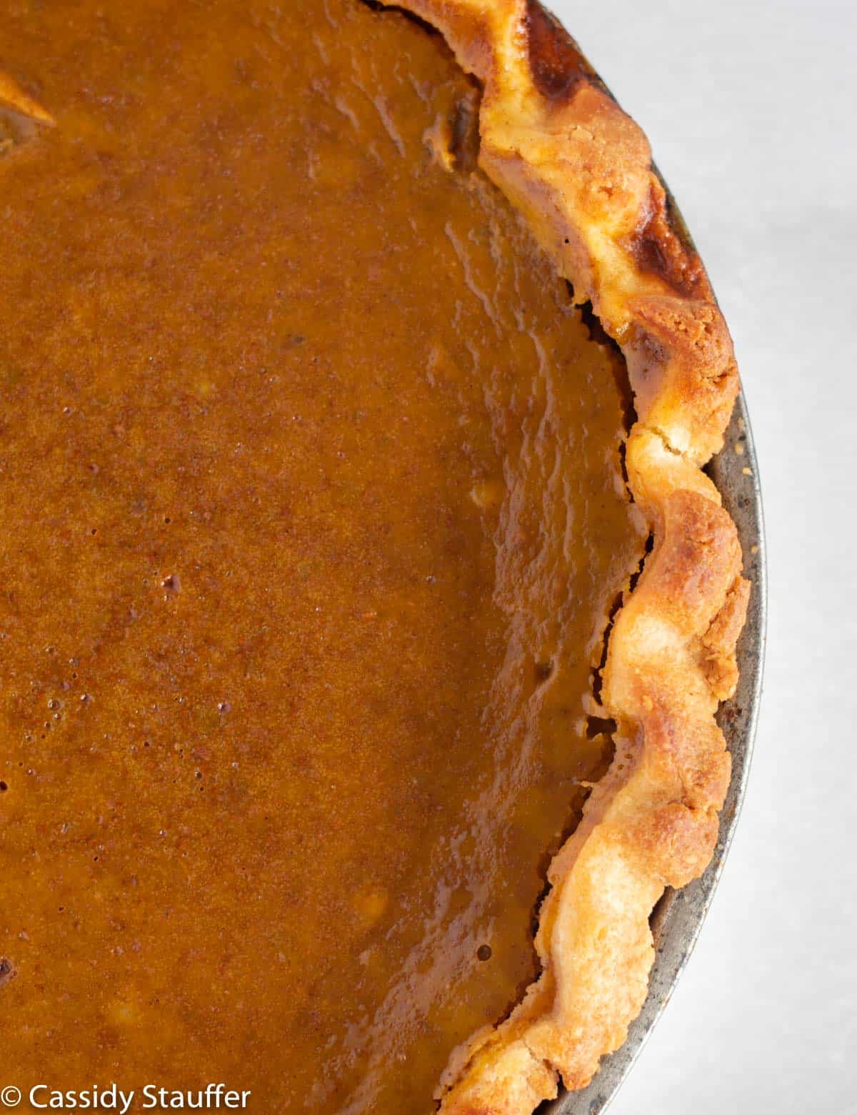 close up of crust of pumpkin pie.
