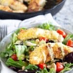 salad with coconut chicken on top with poppyseed dressing