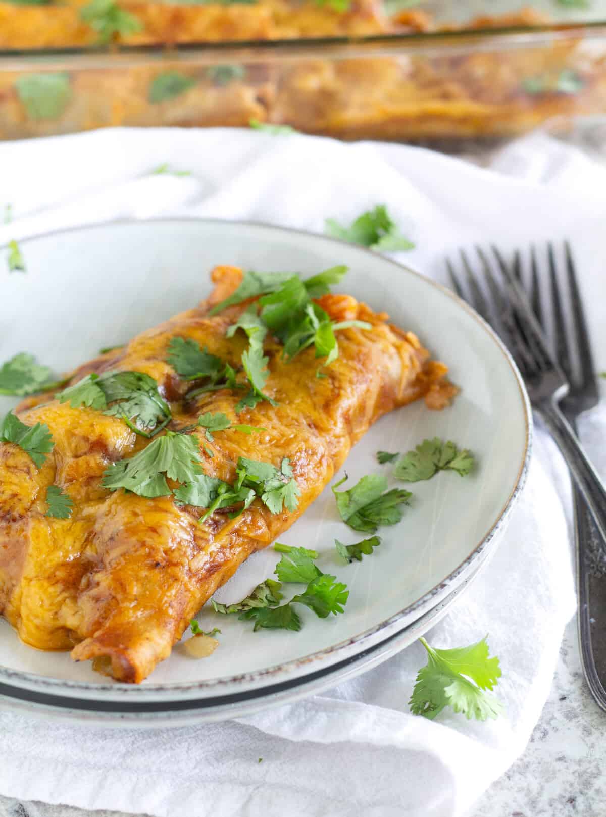 Two Beef Paleo And Keto Enchiladas on plate with cilantro sprinkled on top