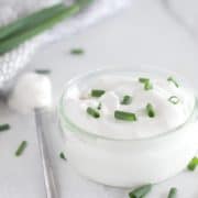 dairy free sour cream out of small clear bowl with green onions