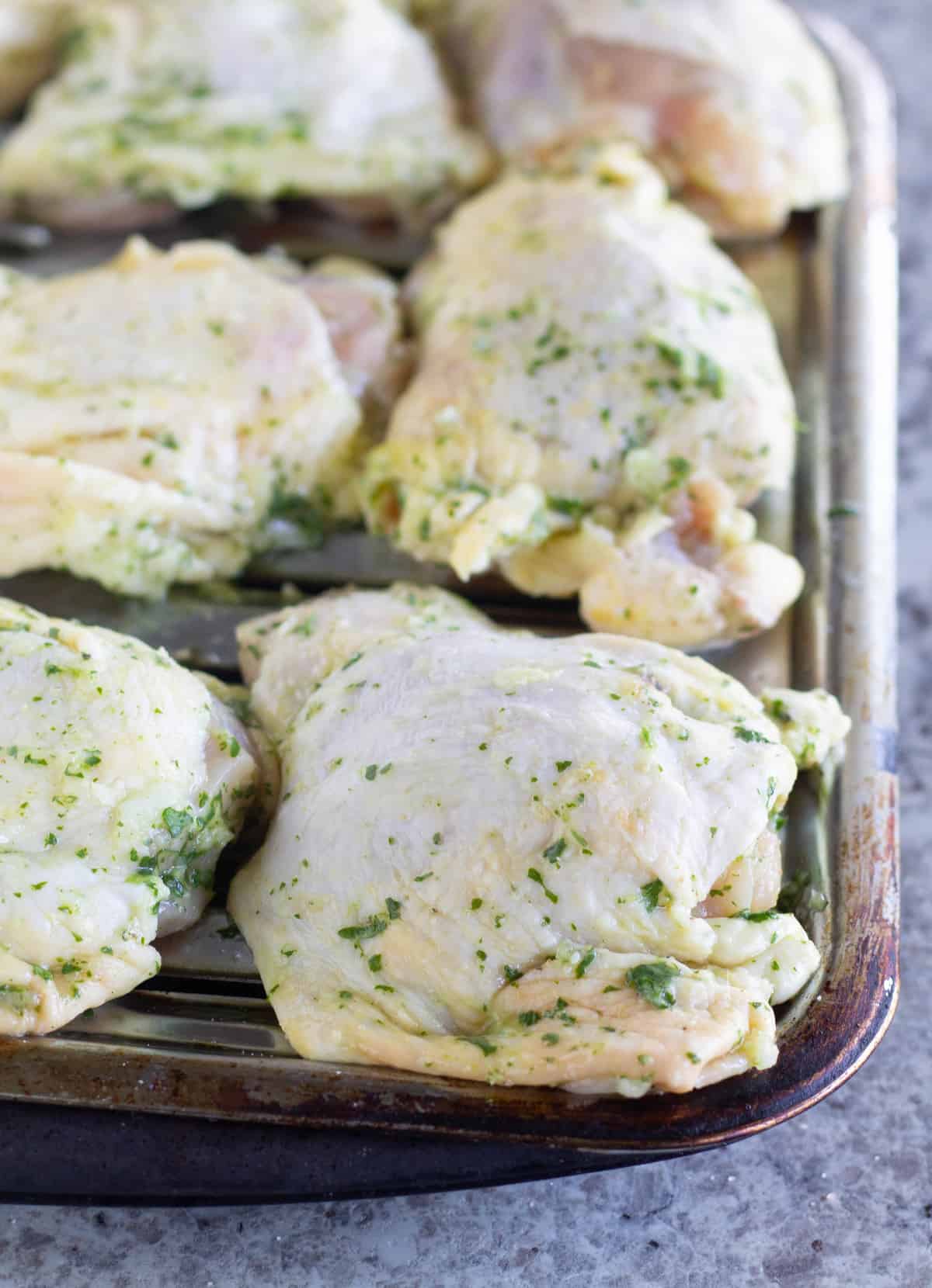 unbaked marinated chicken on broiler pan