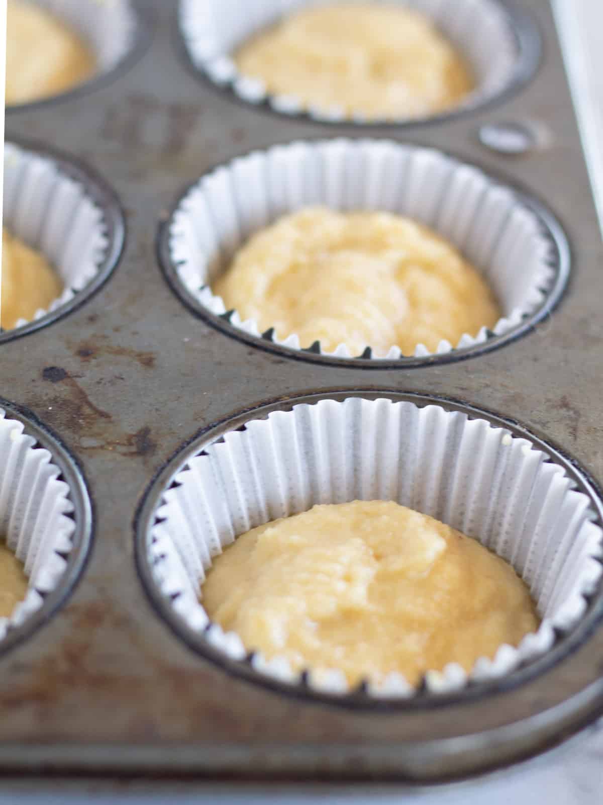 batter in lined muffin tin.