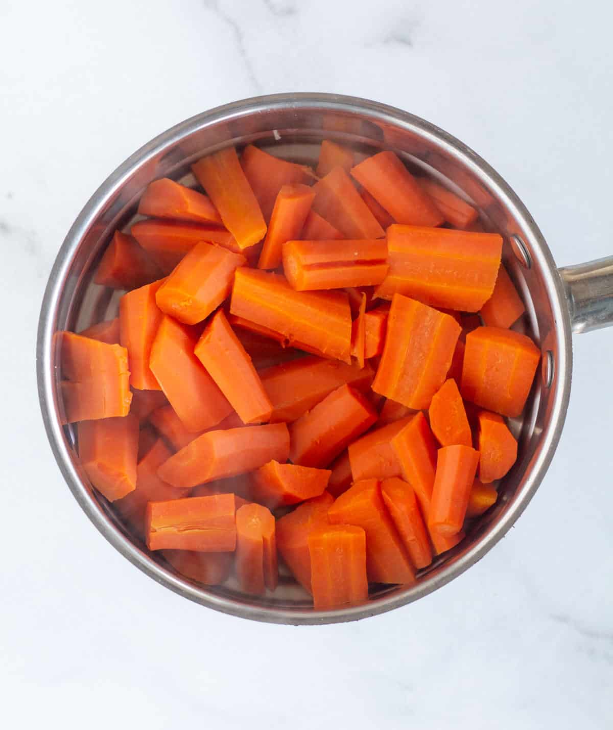 steamed carrots in steamer basket.