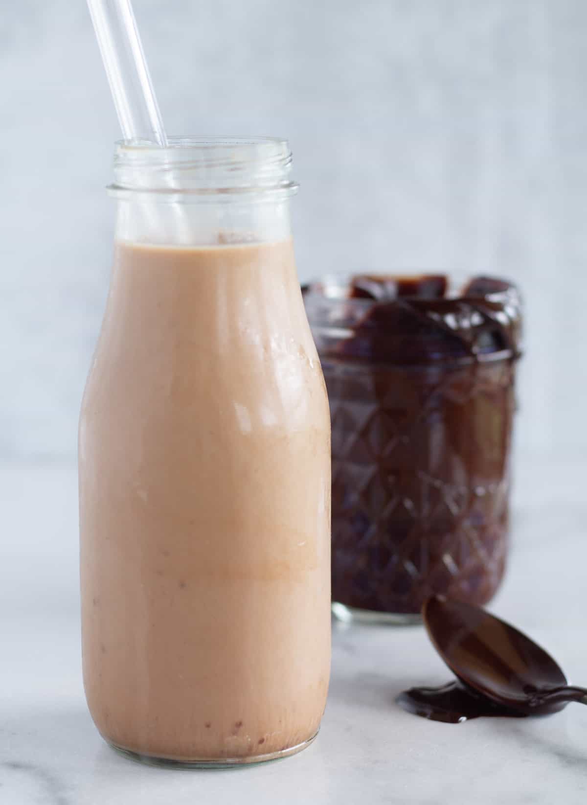chocolate milk with syrup in the background.