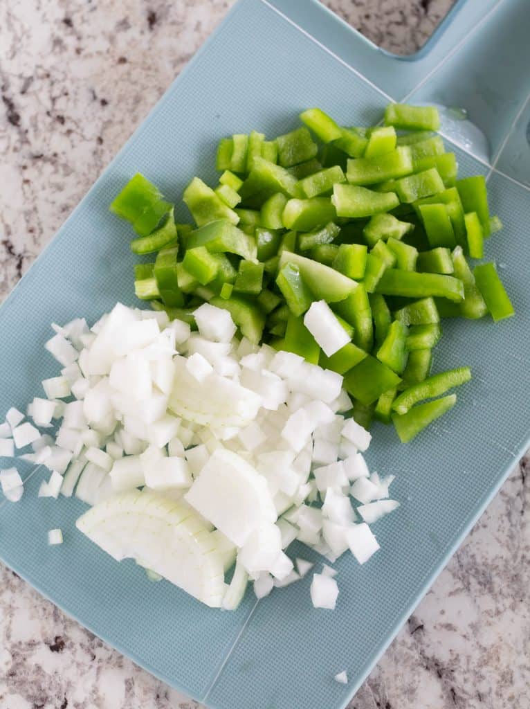 chopped onion and green pepper on cutting board