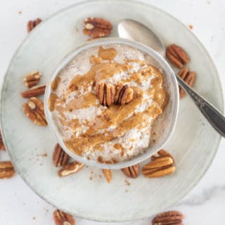 overhead shot of keto oatmeal with nut butter and pecans