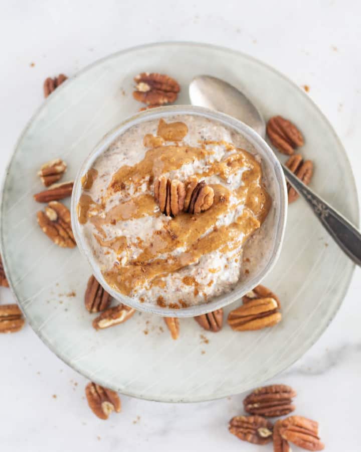 overhead shot of keto oatmeal with nut butter and pecans