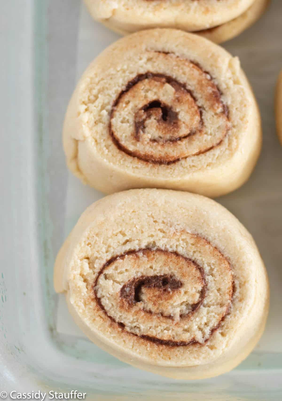unbaked cinnamon rolls in baking dish.
