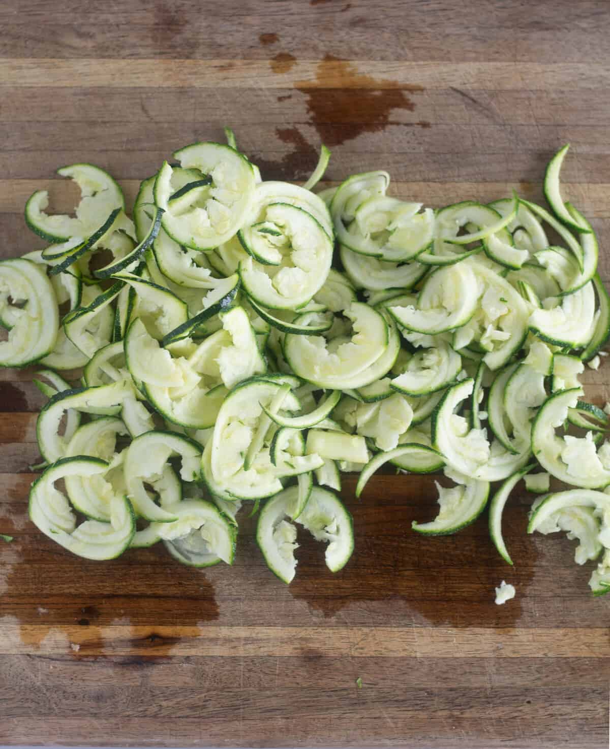 spiralized zucchini on cutting board