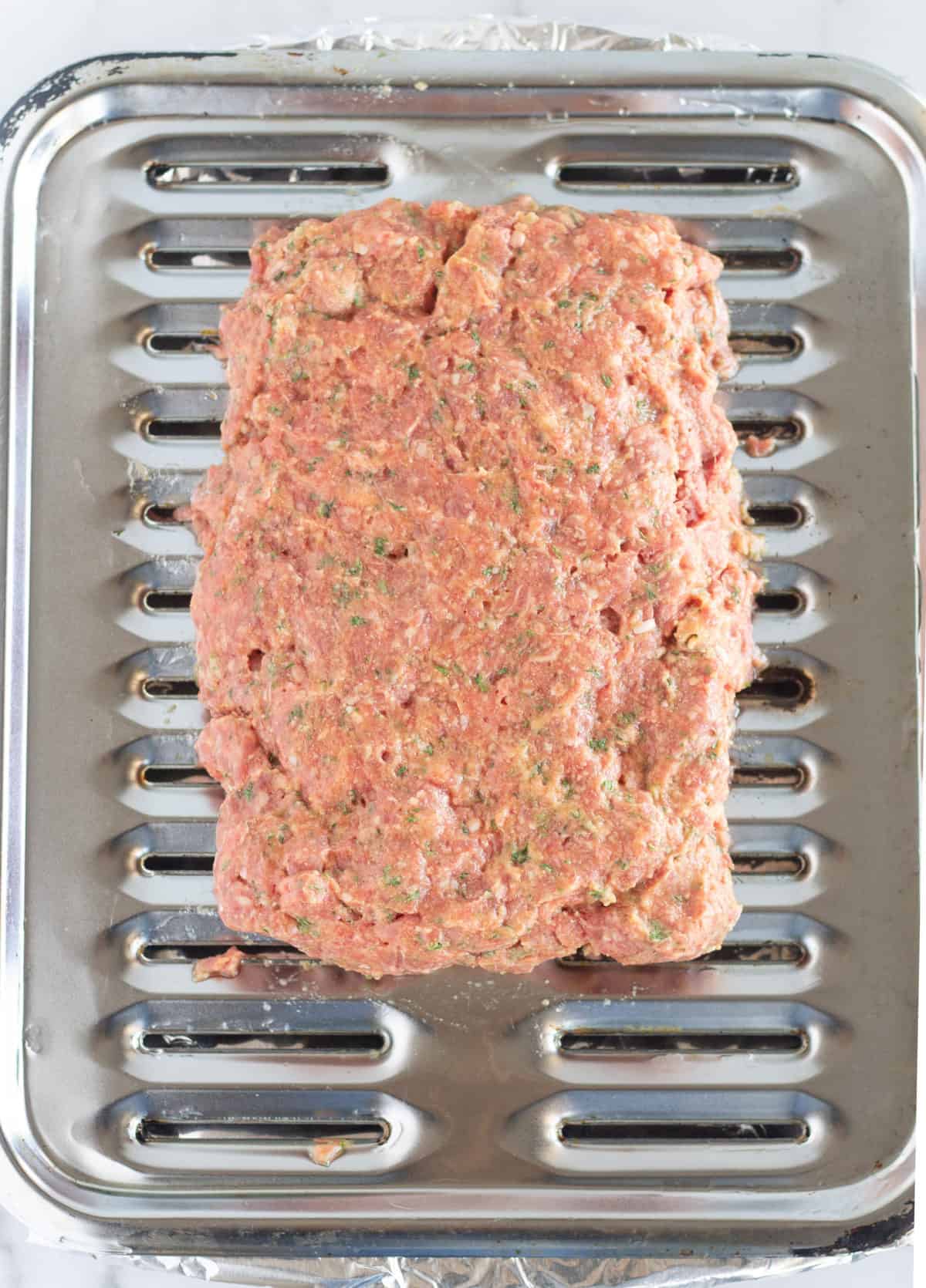 meat mixture formed into loaf on broiler pan