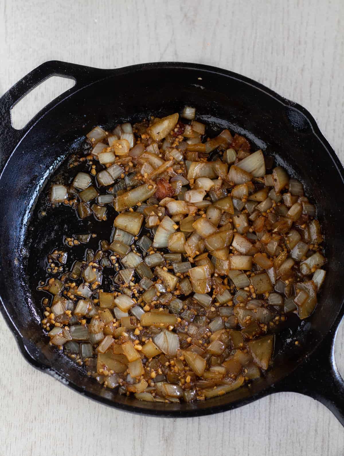 Cooked onion and garlic in a cast-iron skillet.