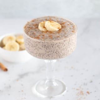 whole30 banana chia pudding in glass dish with sliced bananas