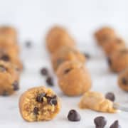 keto peanut butter balls on countertop with chocolate chips