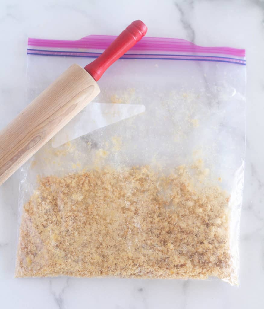 crushed pork rinds in a baggie with a rolling pin