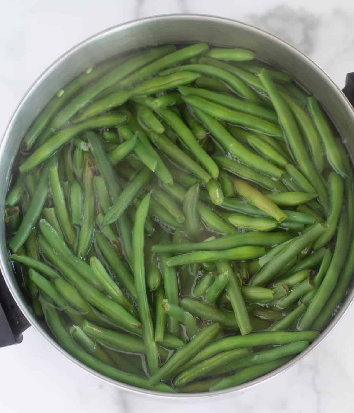 green beans boiling in large pot.