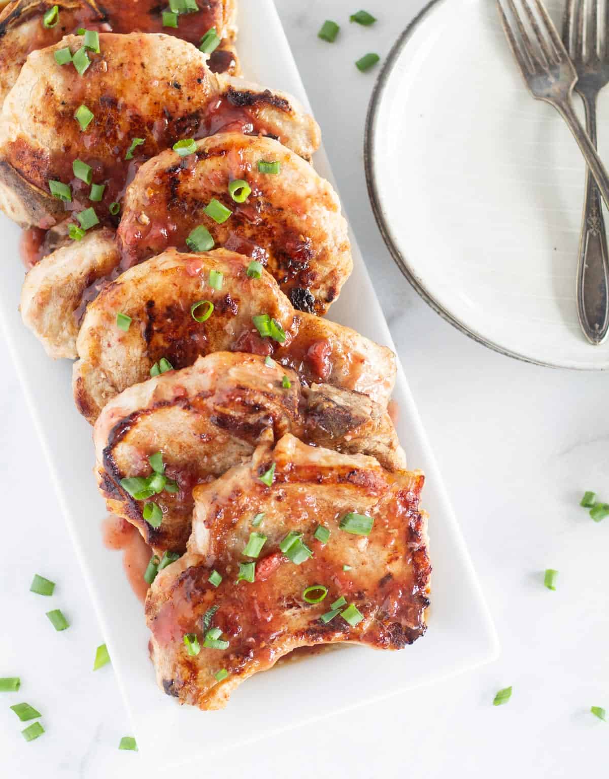overhead shot of low carb pork chops with cherry glaze on platter