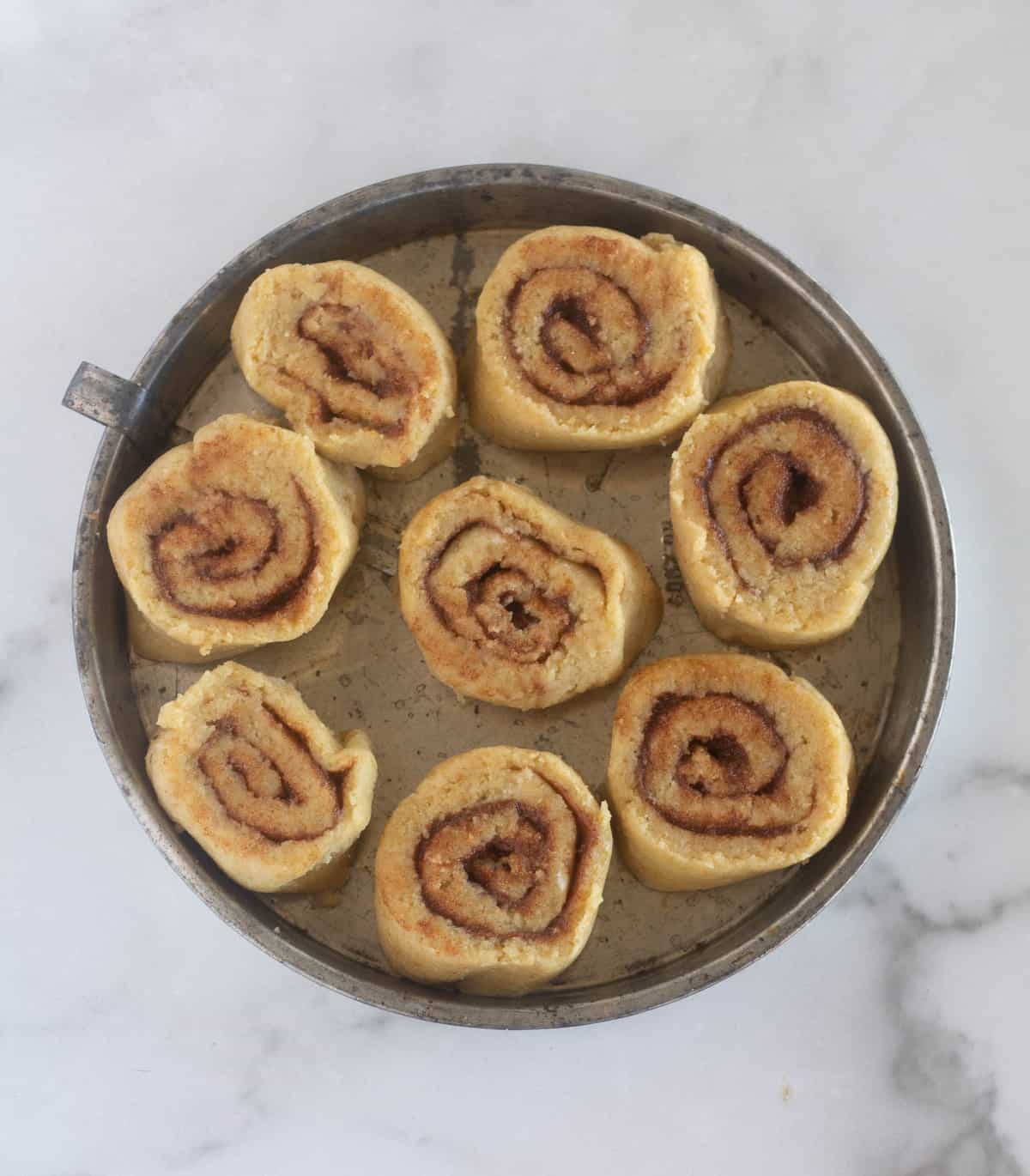 unbaked rolls in pie pan.