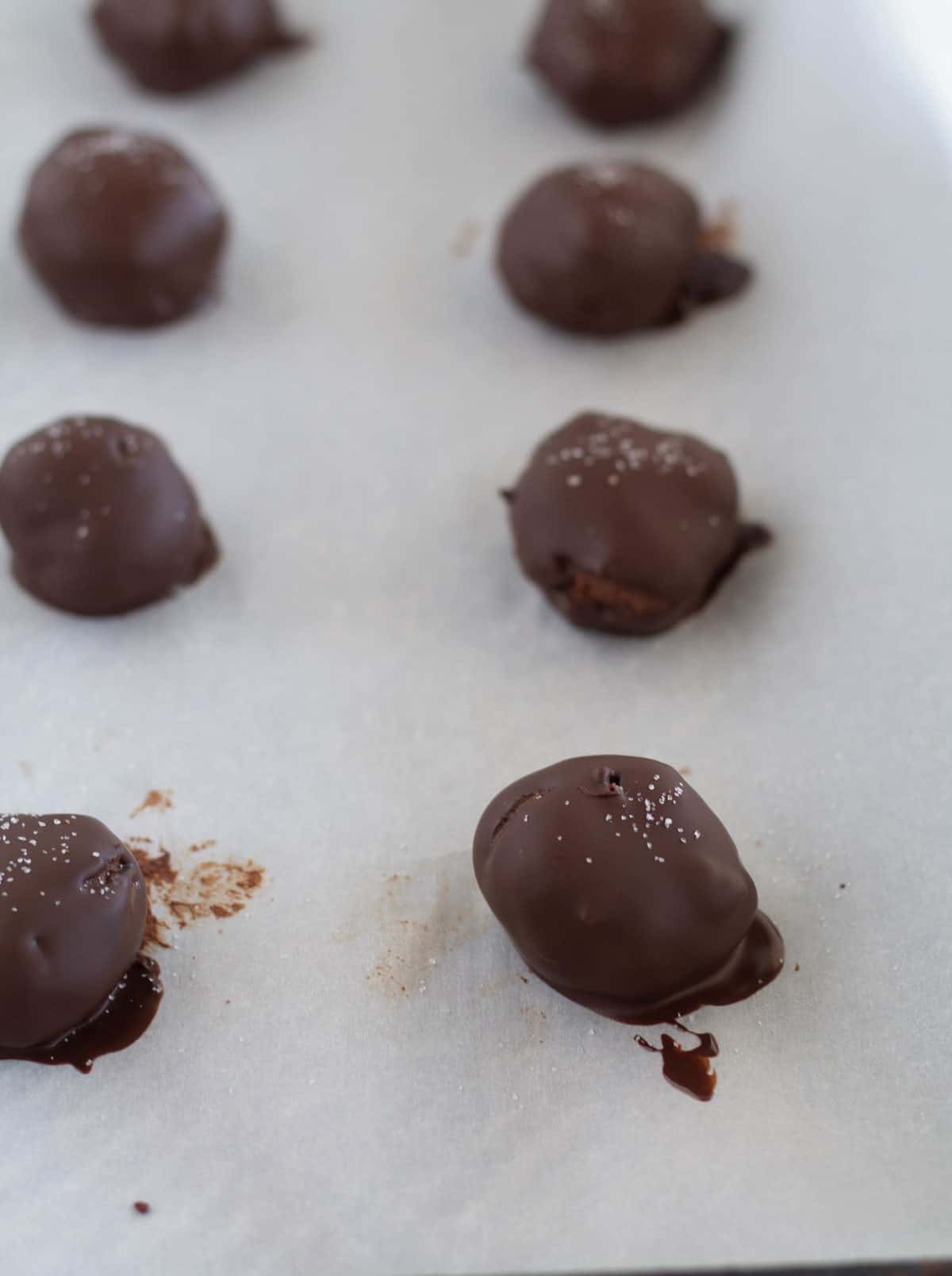 keto truffles on parchment lined baking sheet