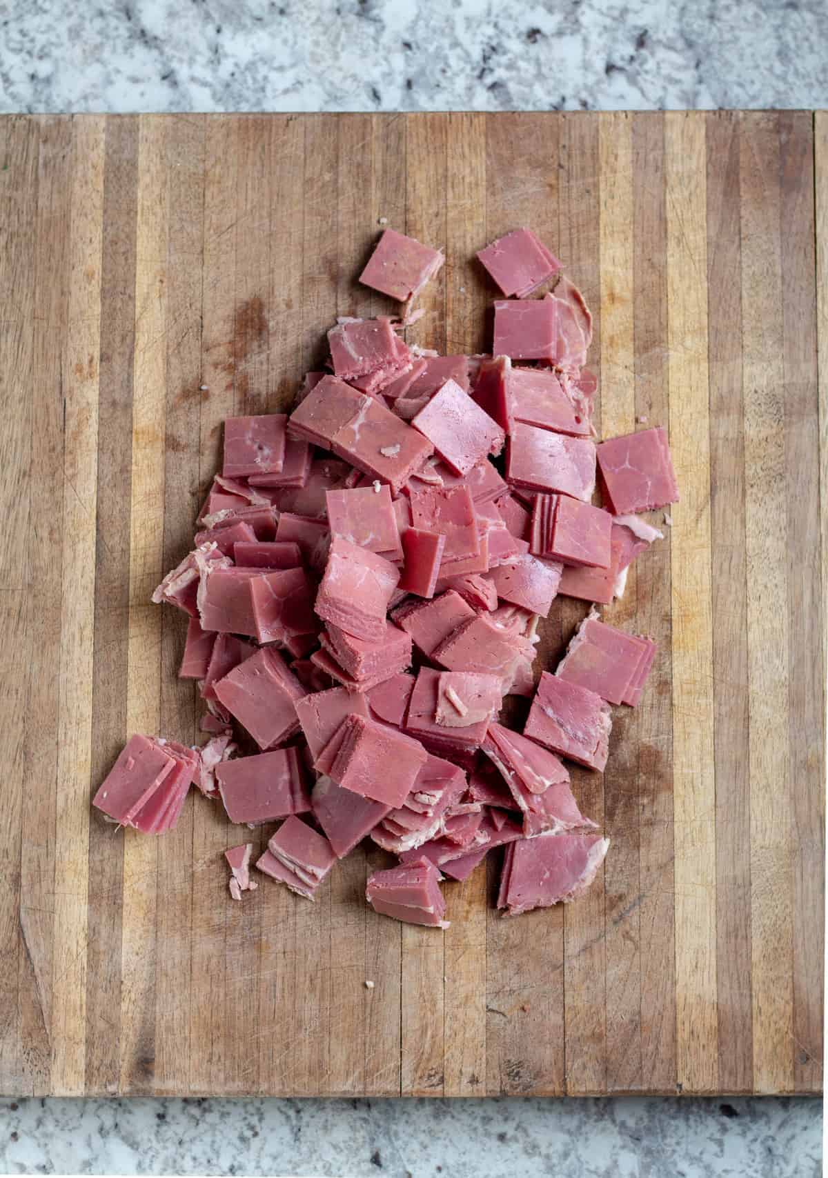 chopped corned beef on wooden cutting board