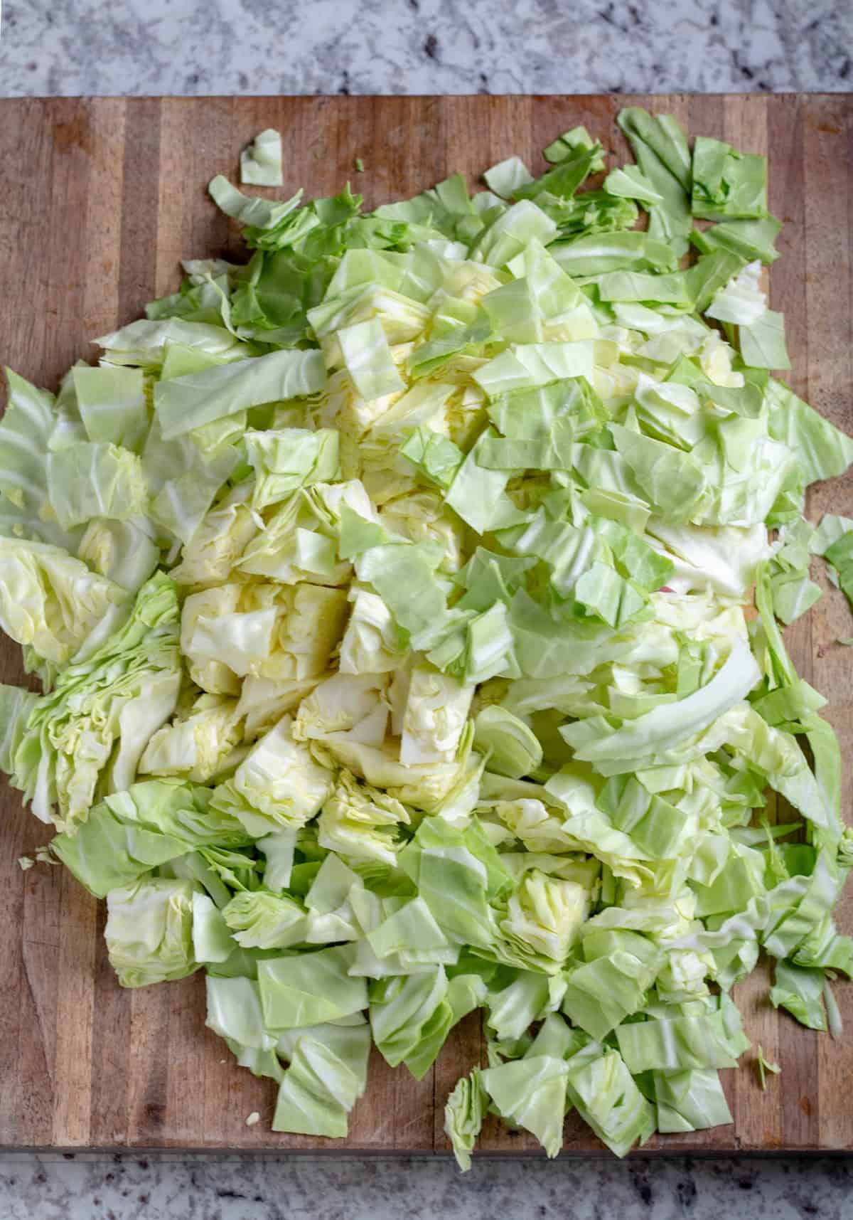 chopped cabbage on wooden cutting board