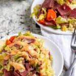 corned beef and cabbage on white plate with dressing