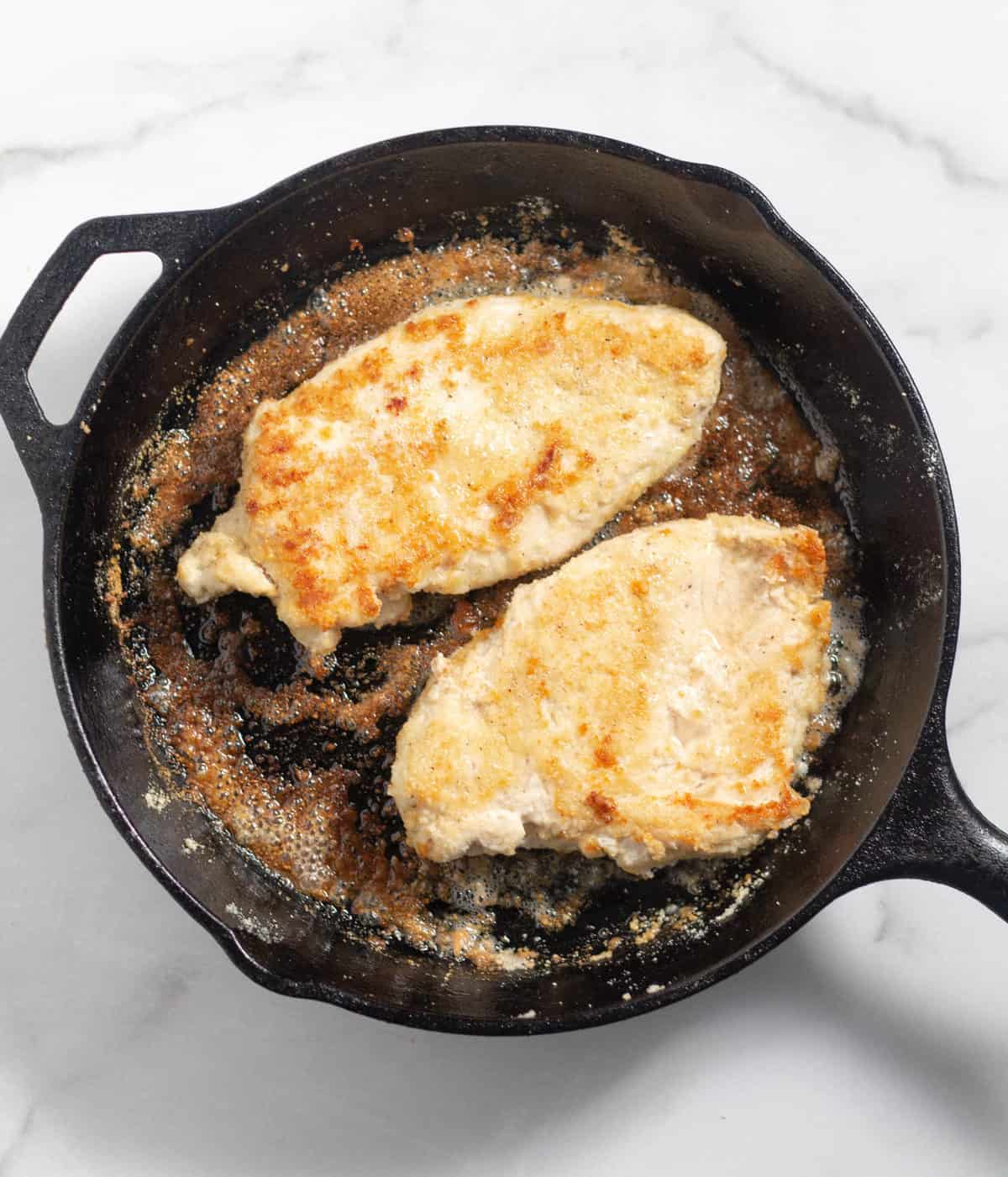 2 grilled chicken breasts in cast iron skillet