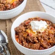 chili in white bowl with garnishes