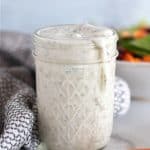 ranch in a mason jar with salad in the background