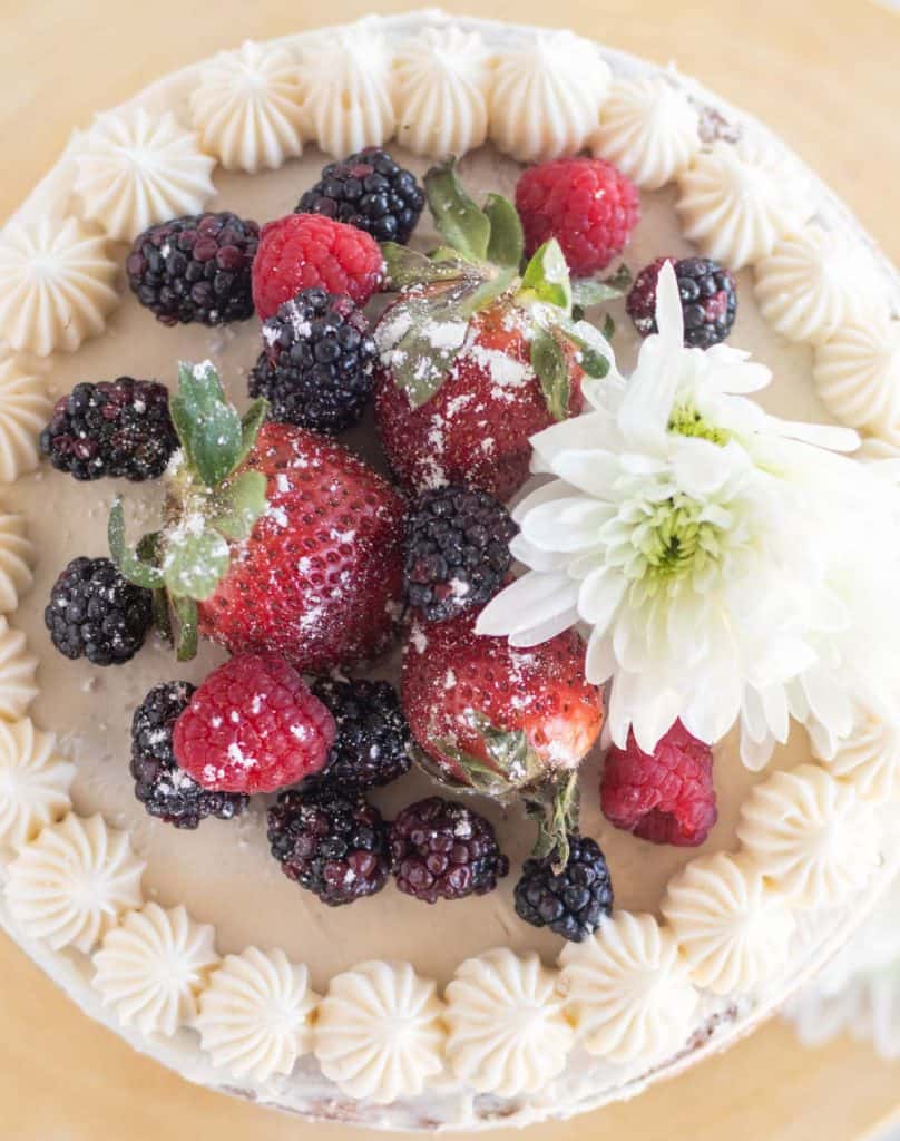 top of cake with berries and flowers