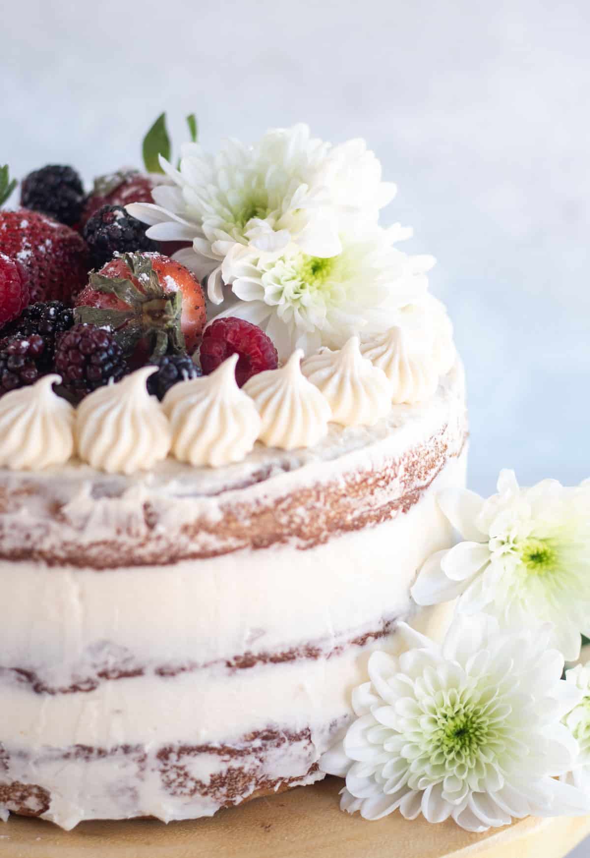 close up of semi-naked frosted cake