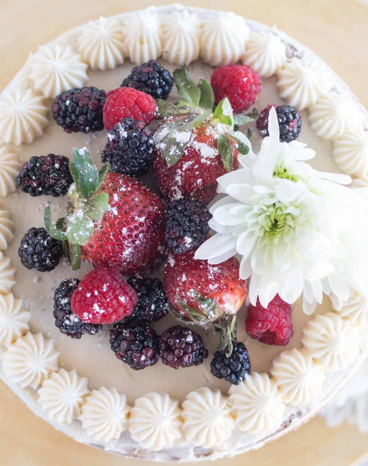 overhead shot of vanilla cake with berries on top.