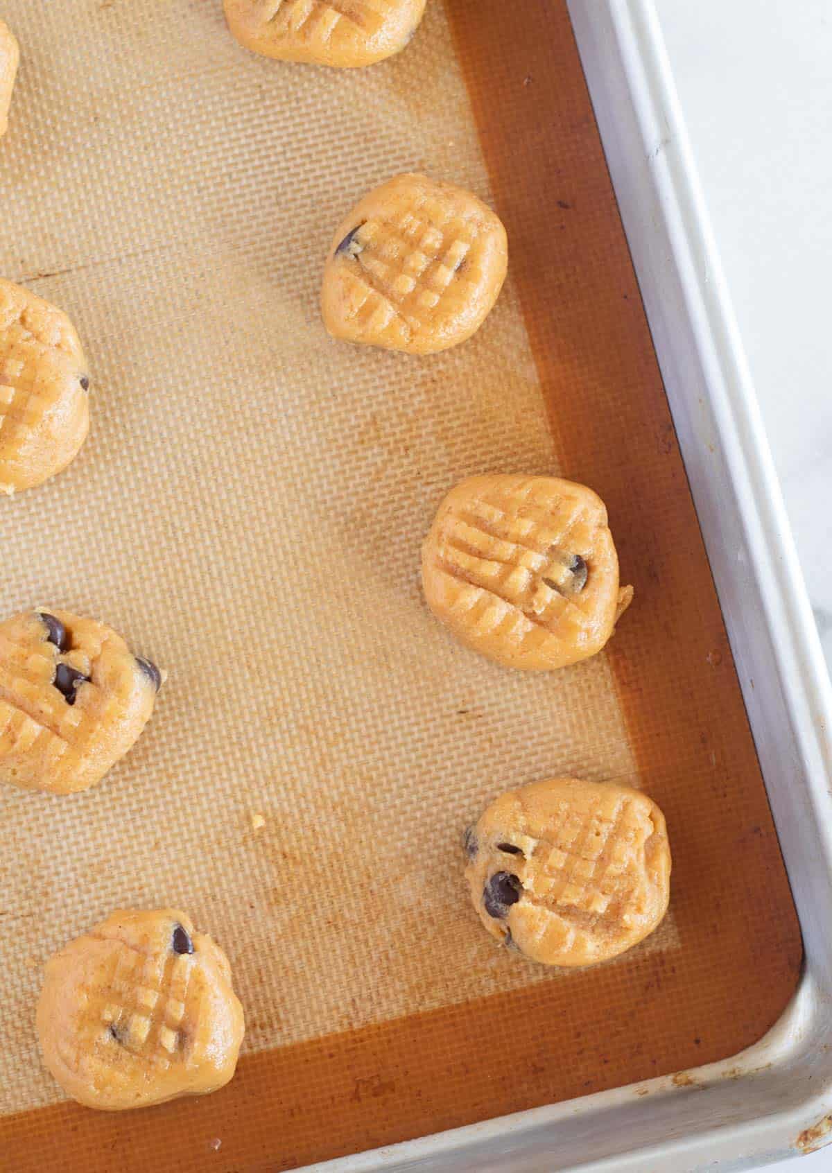 unbaked peanut butter cookies on baking sheet
