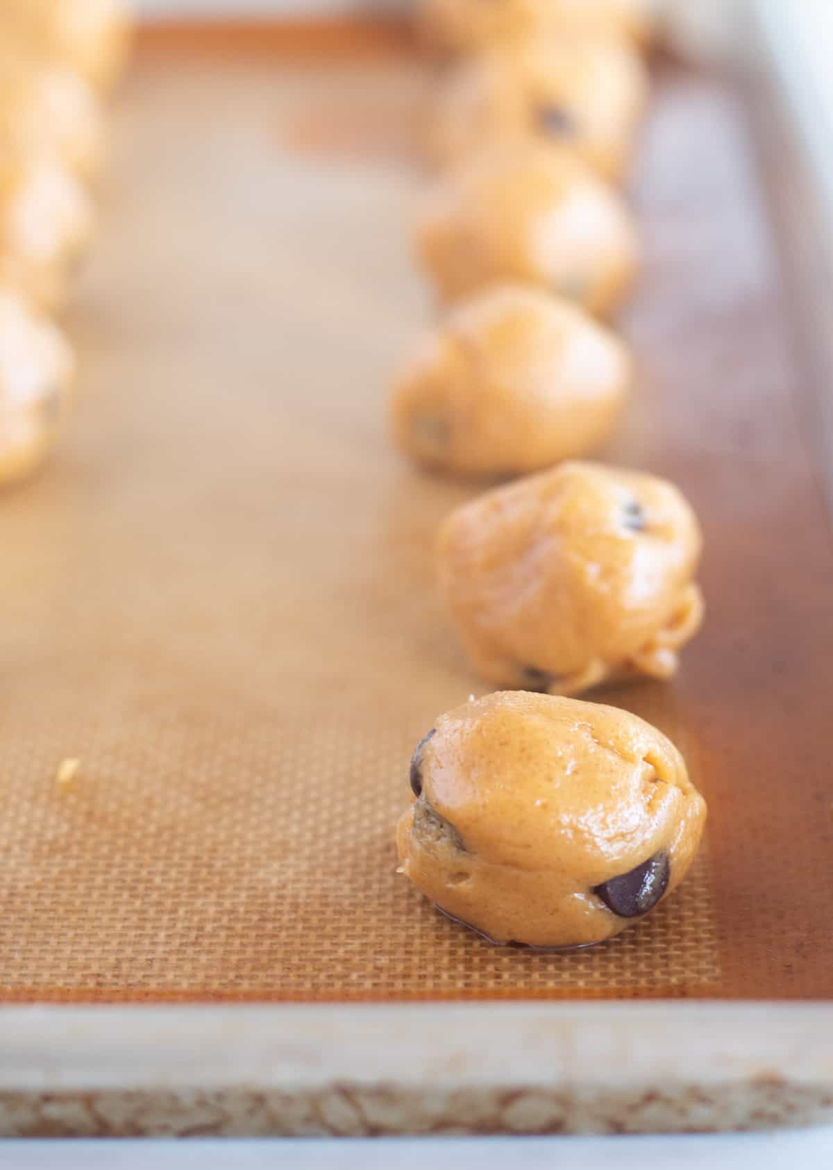 dough rolled into balls on baking sheet