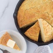 overhead shot of putting a slice of cornbread on a plate