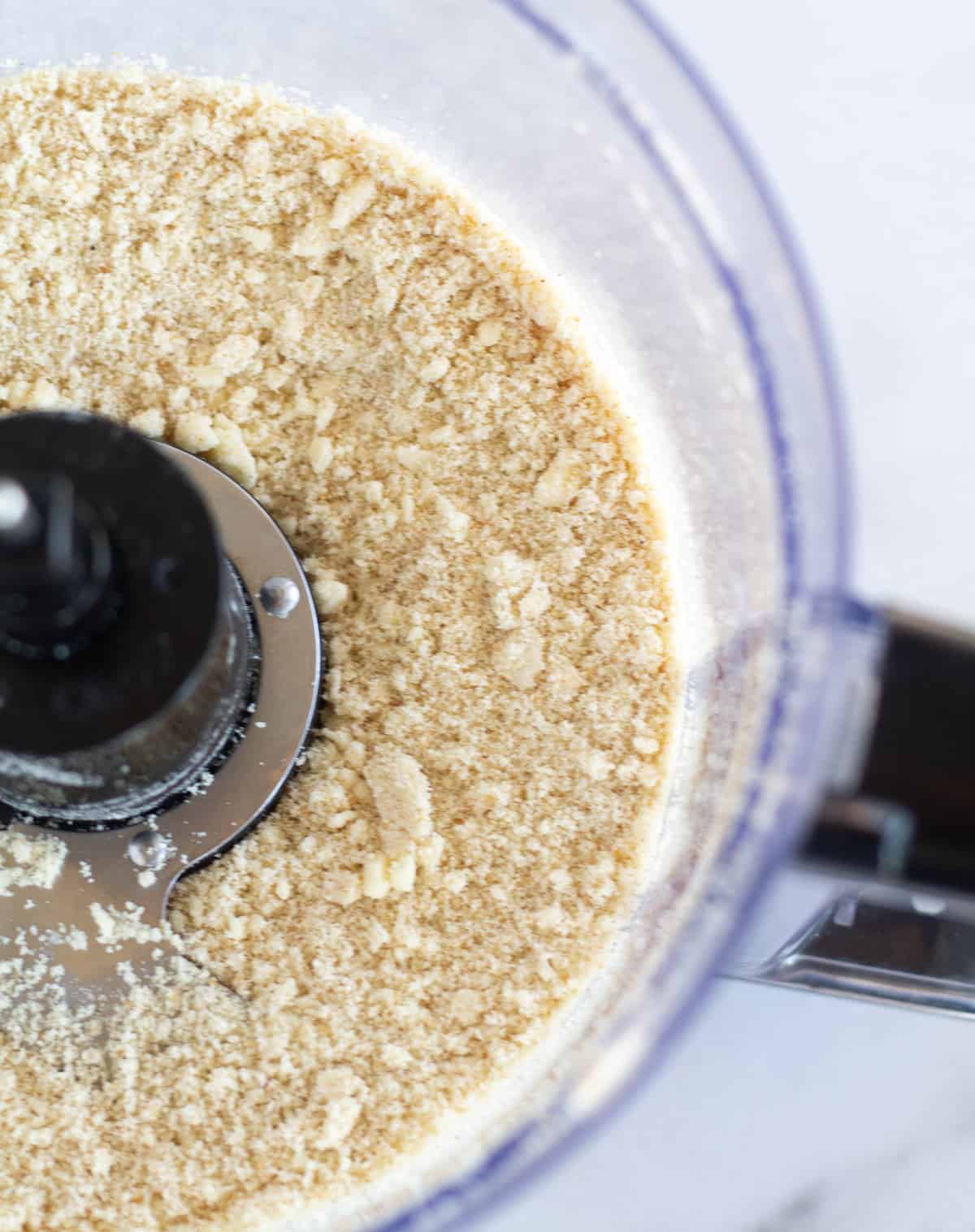 dry ingredients with butter in bowl of food processor