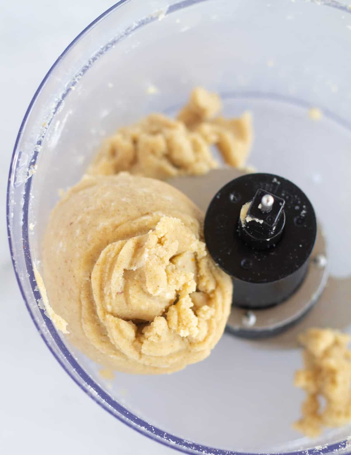 keto pie crust dough in a ball in food processor