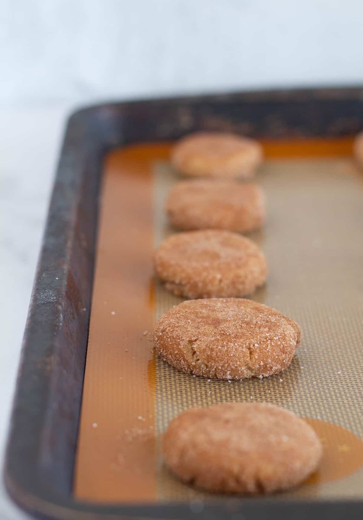 unbaked snickerdoodles on baking sheet