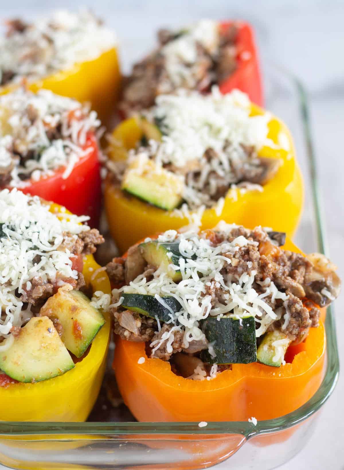 unbaked stuffed peppers in dish