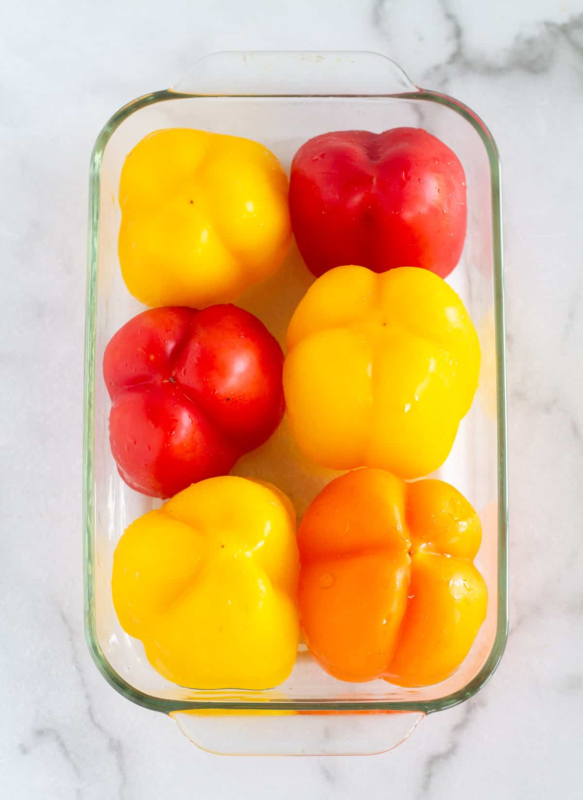 Bell peppers upside down in baking dish.