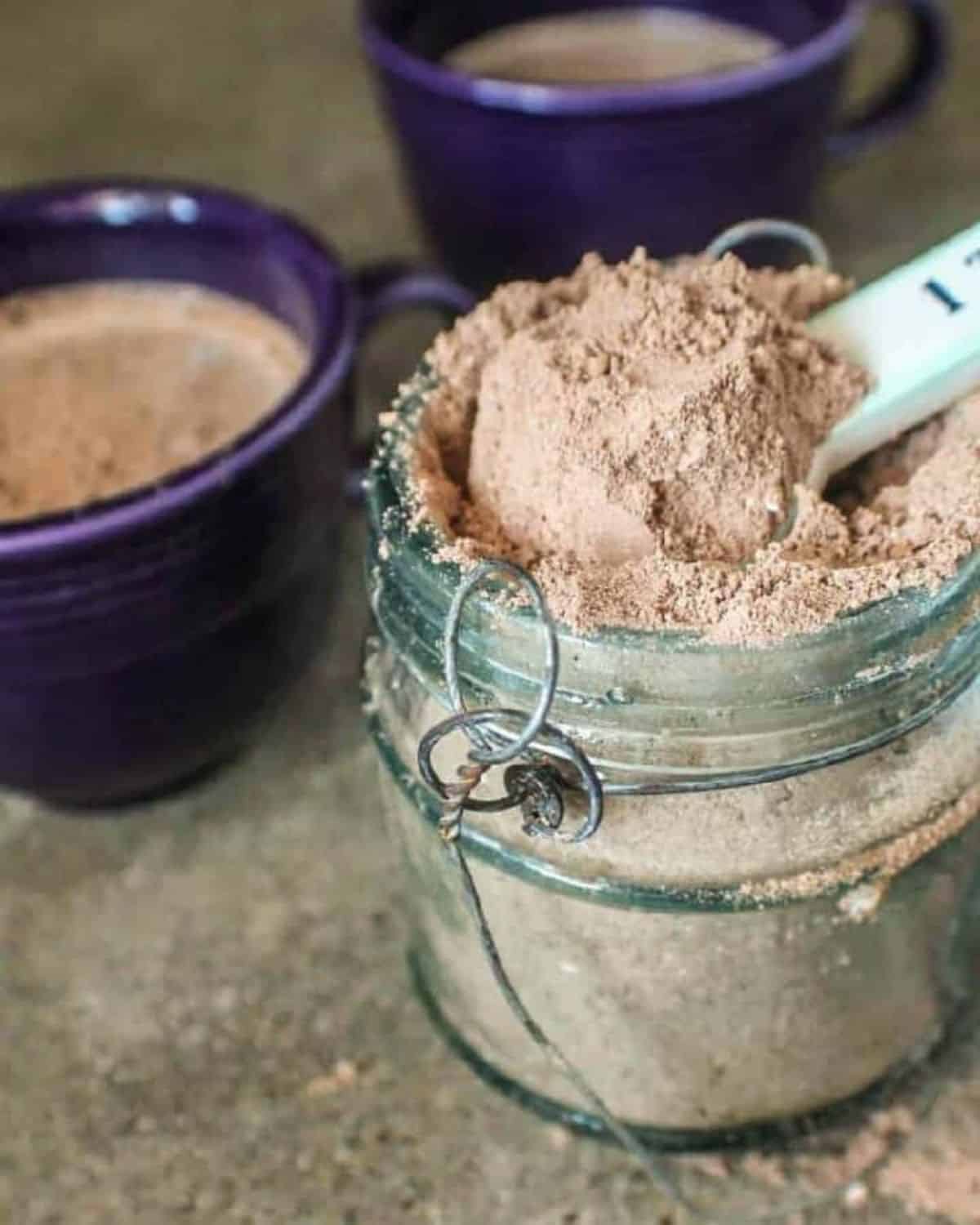 scooping hot chocolate mix out of container