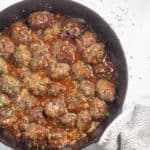 overhead shot of keto sweet and sour meatballs in cast iron skillet