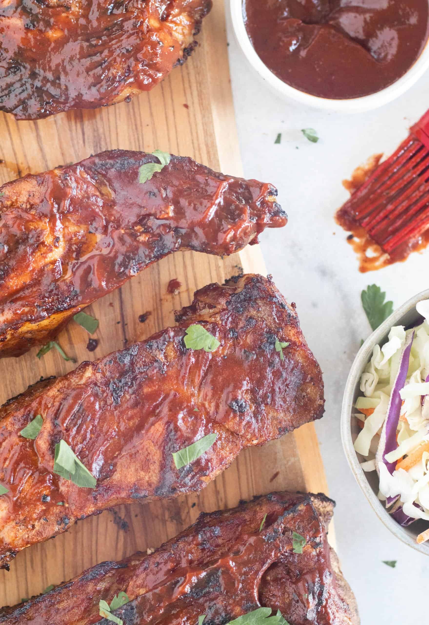 country style ribs lined up on cutting board.
