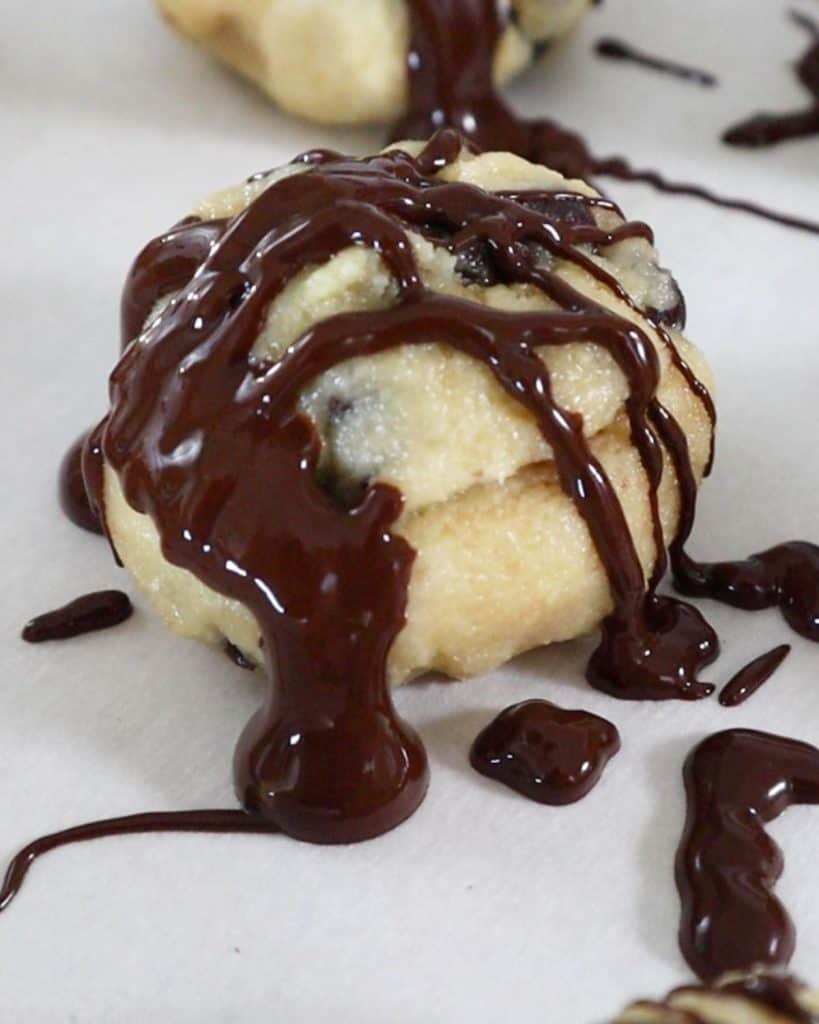 close up of cookie dough bite with melted chocolate