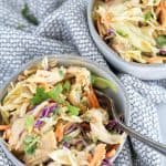 thai chicken salad in 2 bowls with a fork