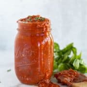 marinara sauce in mason jar with wooden spoon