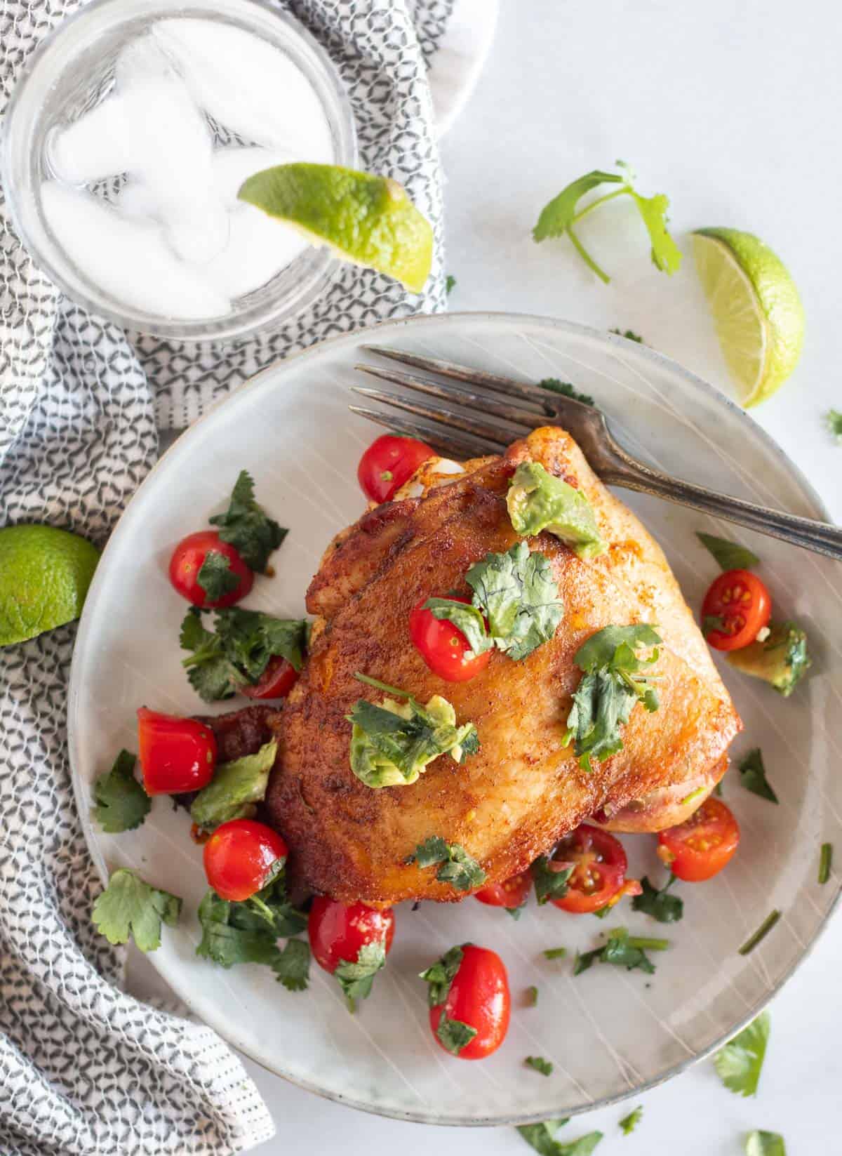 overhead shot of cilantro chicken with salsa on a plate