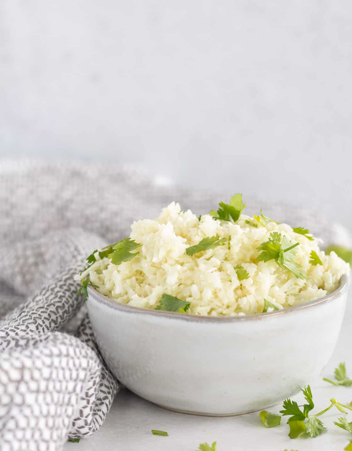 cauliflower rice in small bowl with parsley.