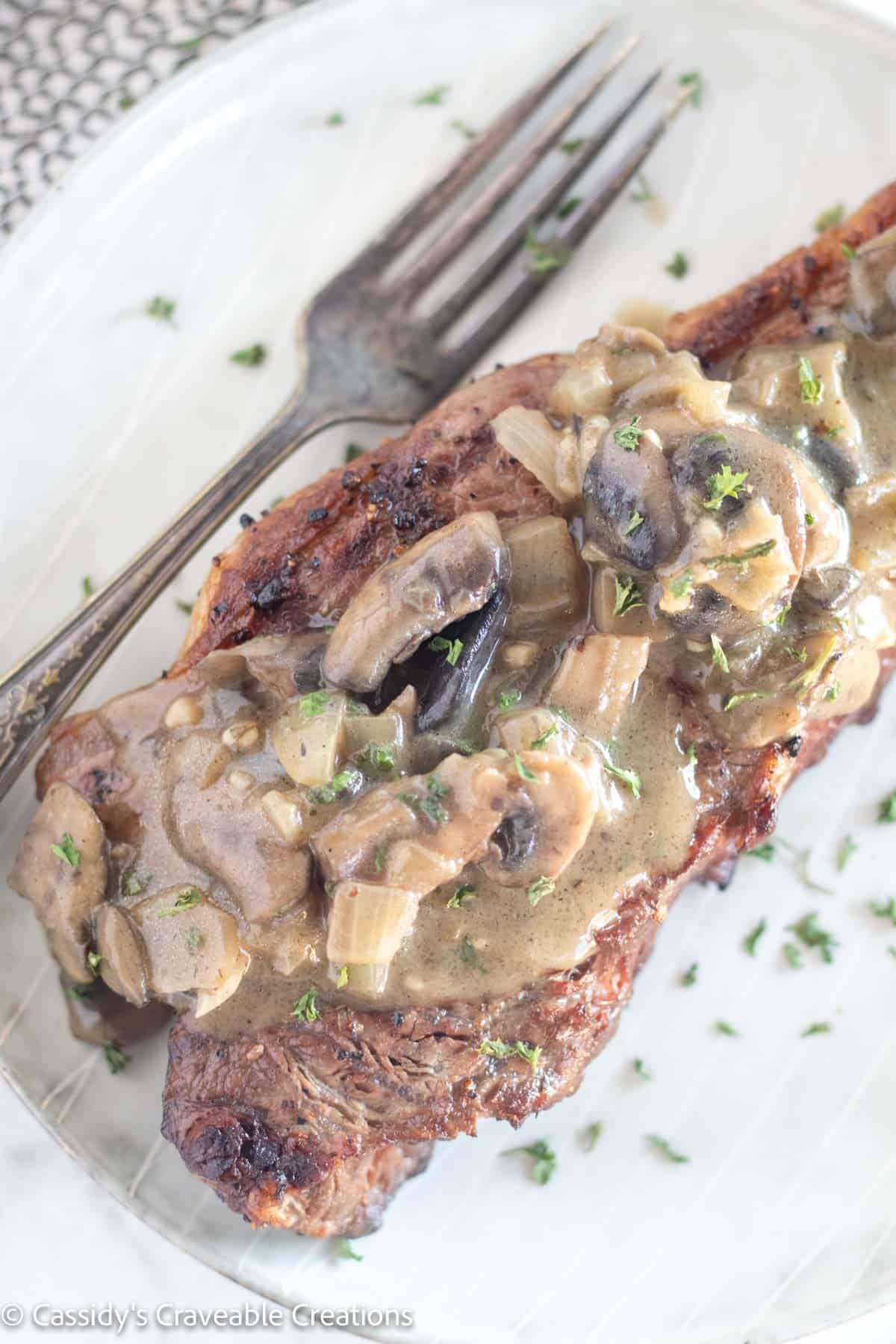 mushroom sauce over steak.