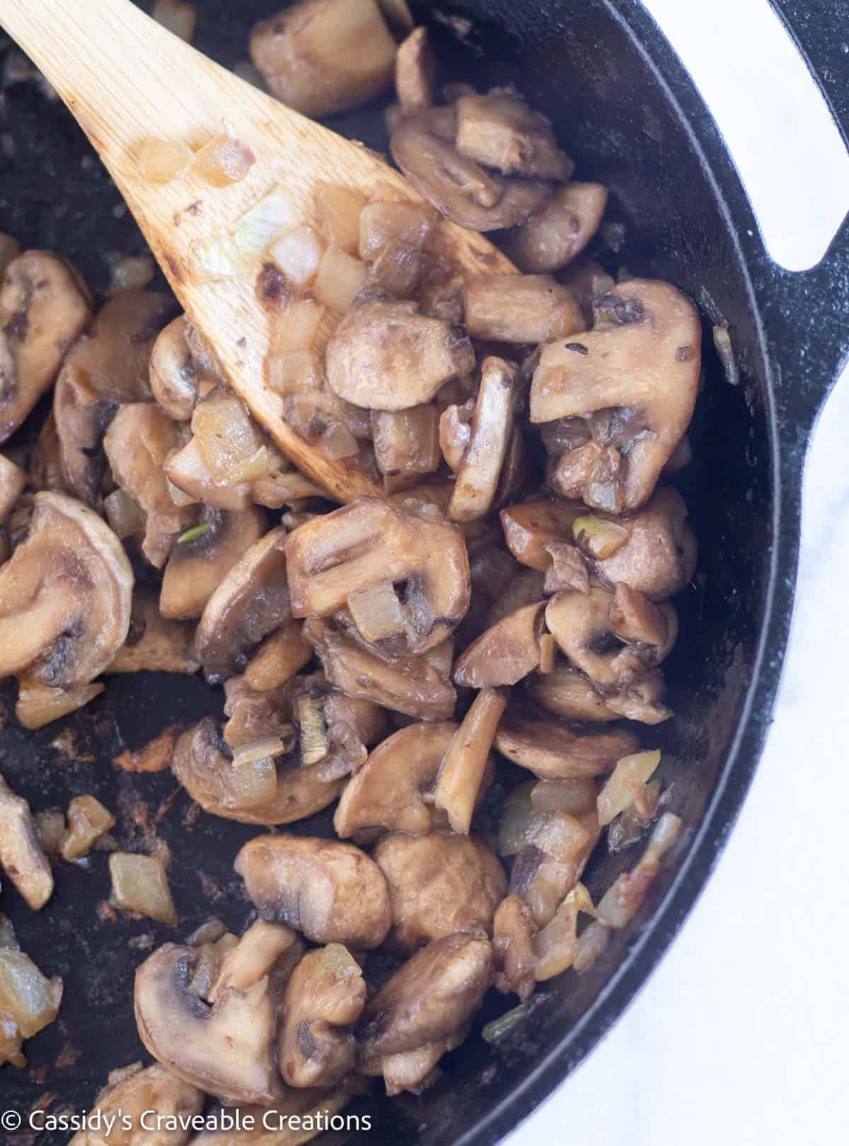 sauteed mushrooms and onion in skillet.